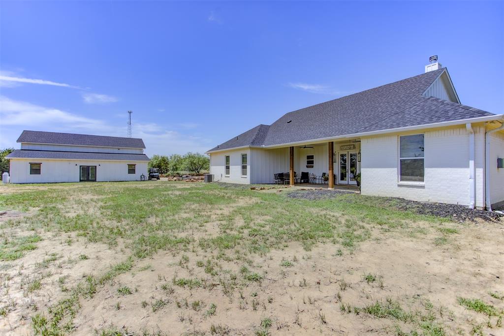 550 Capstone Rdg Road Santo, TX 76472 - Photo 31 of 40 Back of property featuring french doors, roof with shingles, brick siding, a chimney, and a ceiling fan