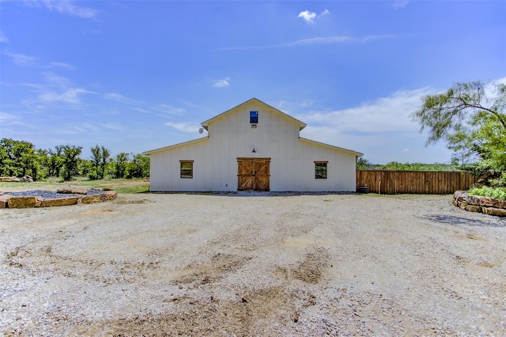 550 Capstone Rdg Road Santo, TX 76472 - Photo 36 of 40 Rear view of property with a barn, board and batten siding, and an outdoor structure