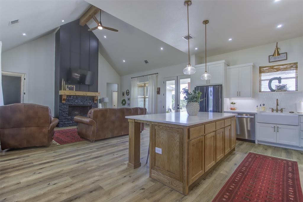 550 Capstone Rdg Road Santo, TX 76472 - Photo 40 of 40 Kitchen with stainless steel appliances, open floor plan, a sink, high vaulted ceiling, and beam ceiling