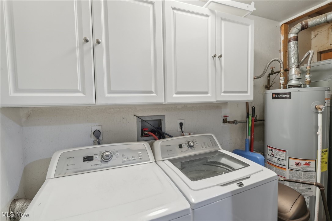 167 Birch Road Painesville, OH 44077 - Photo 25 of 49 Clothes washing area with cabinets, water heater, and washer and dryer