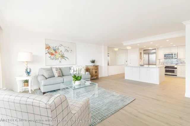 a living room with furniture and kitchen view