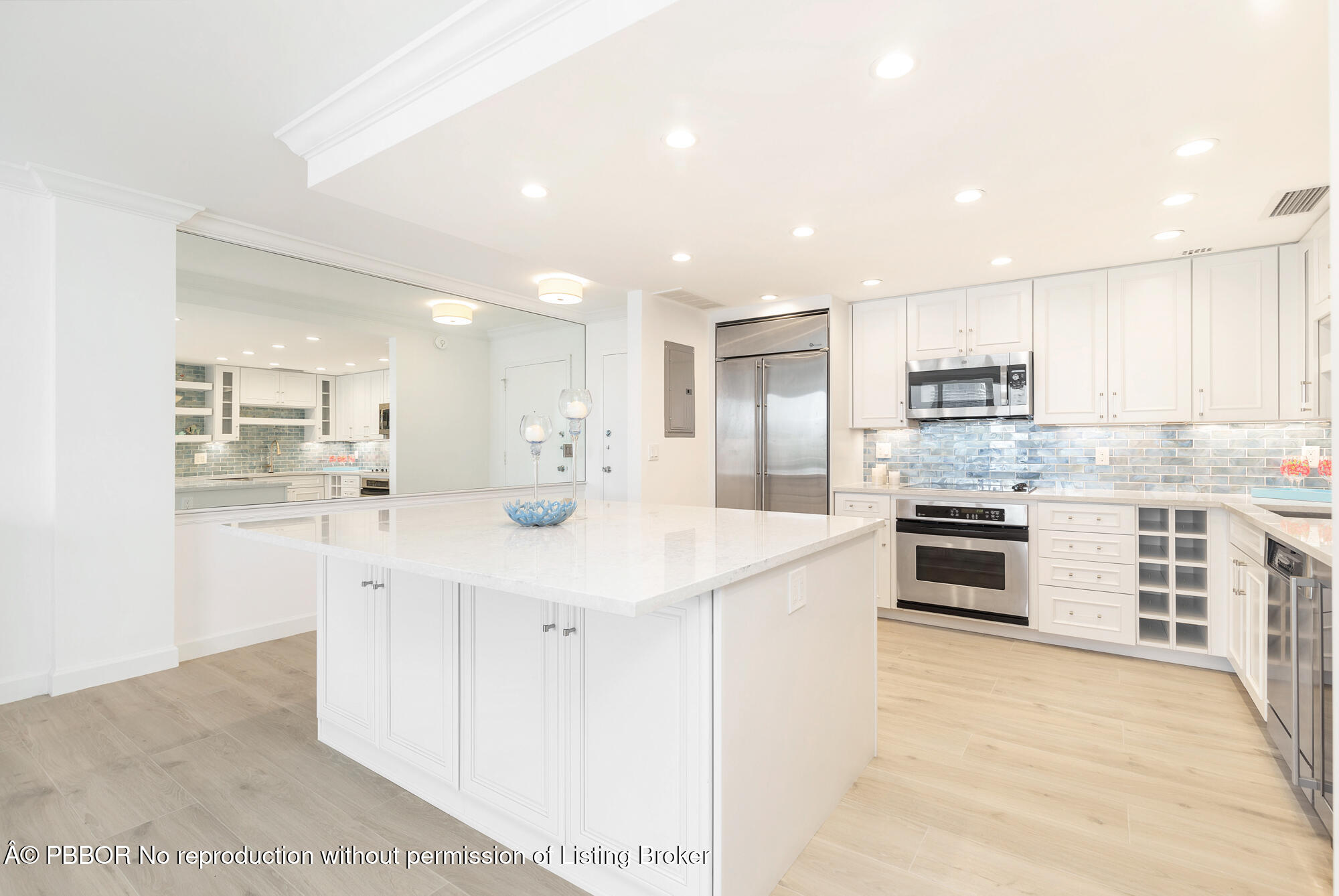 354 Chilean Avenue, Unit 6C Palm Beach, FL 33480 - Photo 7 of 21 a kitchen with stainless steel appliances kitchen island granite countertop a stove and a sink