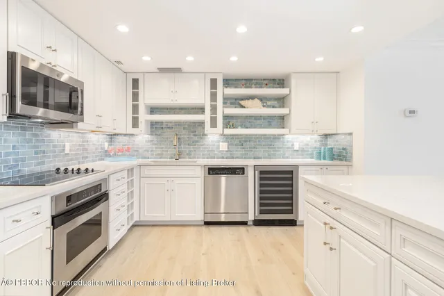 a kitchen with stainless steel appliances granite countertop a stove and a sink