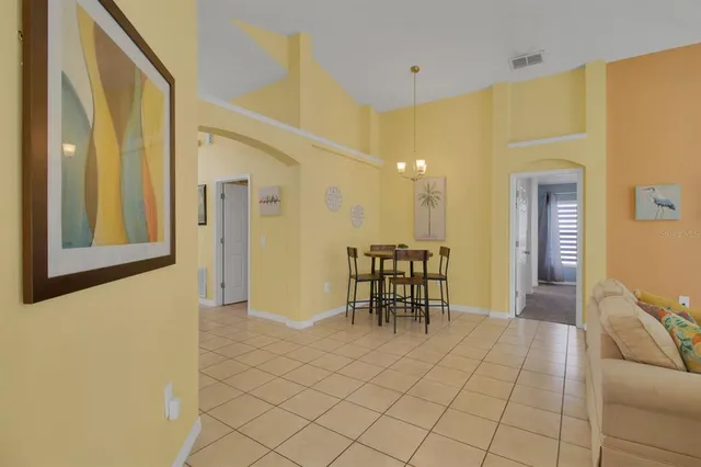 a view of a hallway with furniture and a dining table
