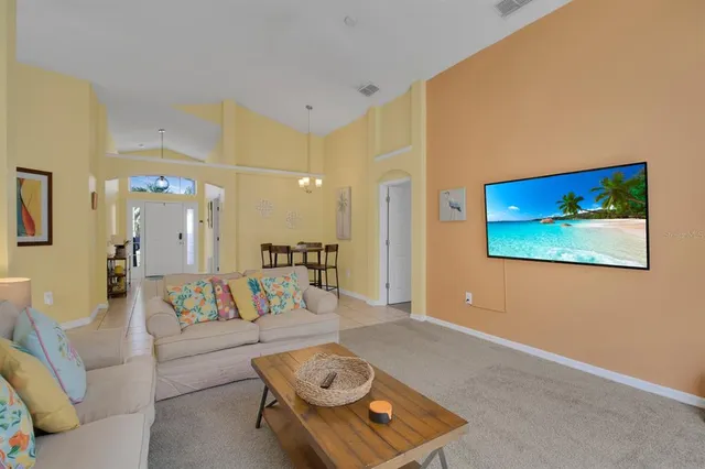 a living room with furniture and a view of bathroom