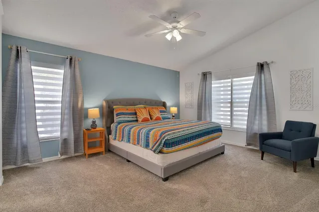 a bedroom with a bed couch and a window