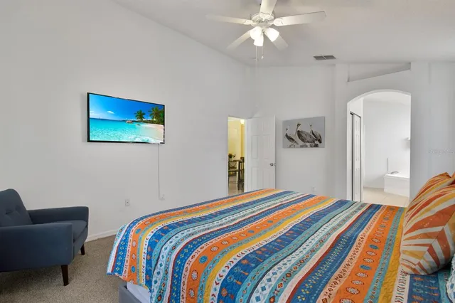a bedroom with bed and a chandelier