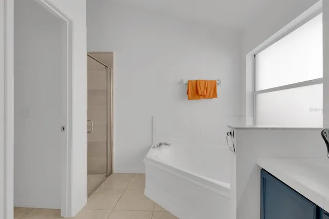 a bathroom with a bathtub and a window
