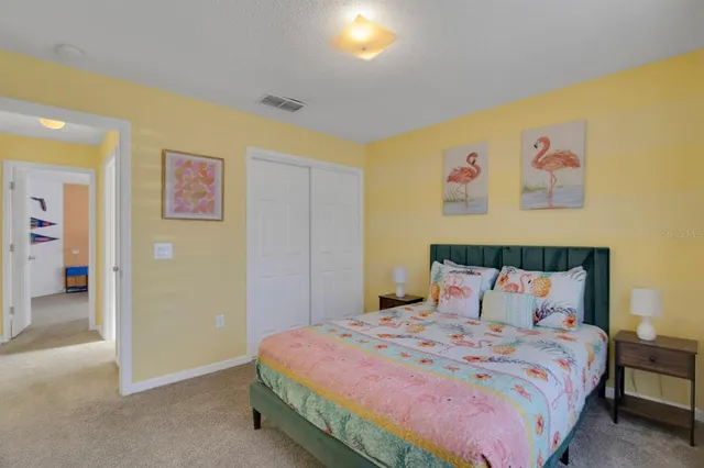 a bedroom with a bed and cupboard