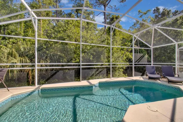 a view of a swimming pool with a garden and sitting area