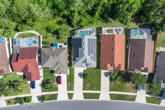an aerial view of residential house with outdoor space and trees