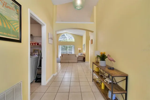 a hallway with dining area and chandelier