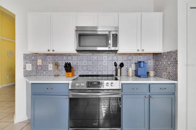 a kitchen with stainless steel appliances granite countertop a stove a microwave and cabinets