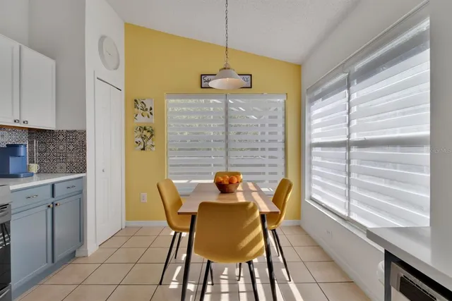 a dining room with a window and chairs