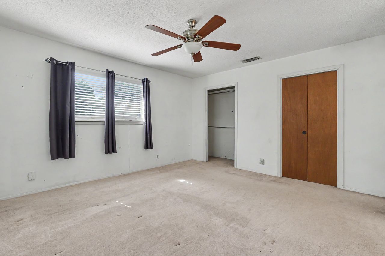 1811 Terry Lane Georgetown, TX 78628 - Photo 19 of 40 Well-lit sleeping quarters with a ceiling fan, plush carpet, and convenient closet storage.