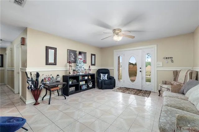 a living room with furniture and a ceiling fan