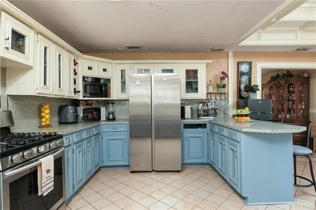 a kitchen with stainless steel appliances granite countertop a refrigerator a stove top oven a sink and dishwasher