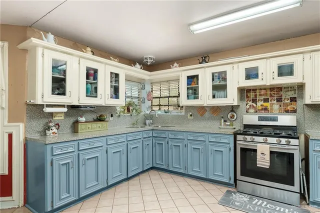 a kitchen with stainless steel appliances granite countertop a stove sink and cabinets