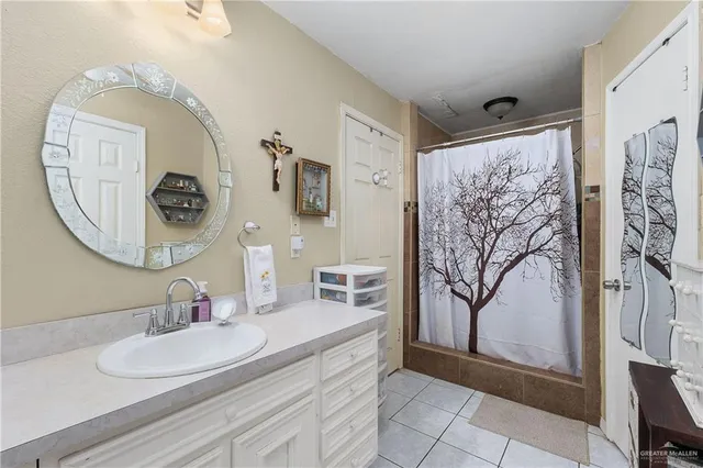 a bathroom with a granite countertop sink mirror and vanity