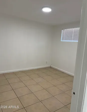 a view of a room with white tiles