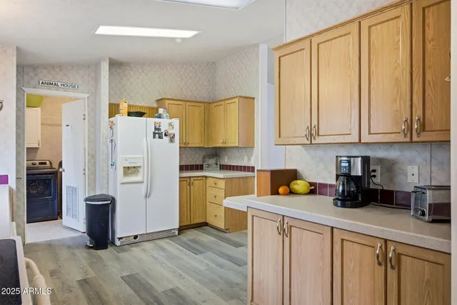 a kitchen with stainless steel appliances a stove a sink and a refrigerator