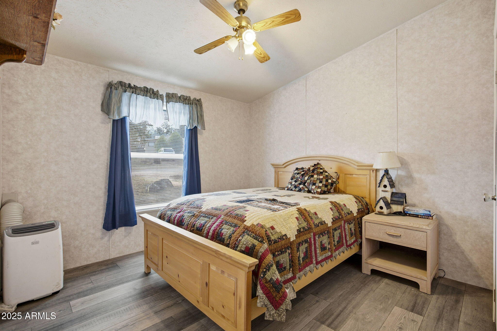 2190 Wildlife Trail Overgaard, AZ 85933 - Photo 19 of 34 a bed sitting in a bedroom next to a window