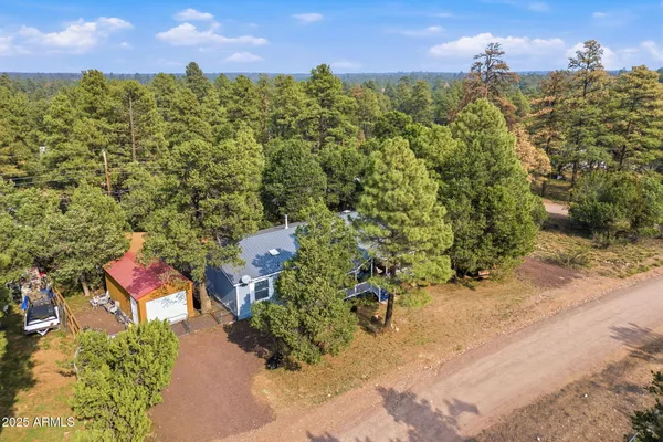 an aerial view of a houses with a yard