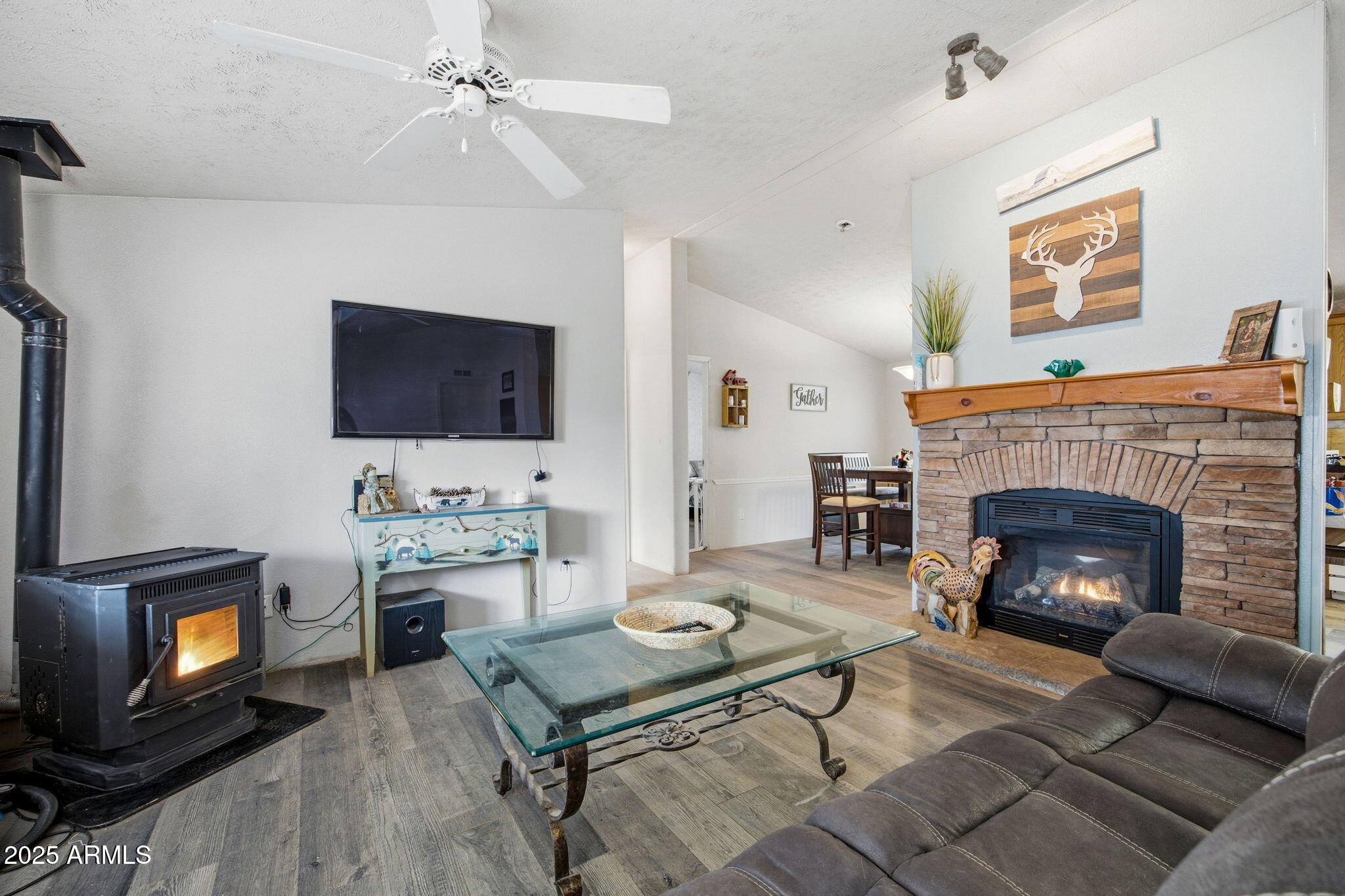 2190 Wildlife Trail Overgaard, AZ 85933 - Photo 6 of 34 a living room with furniture a flat screen tv and a fireplace