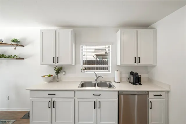 a kitchen with a sink cabinets and window