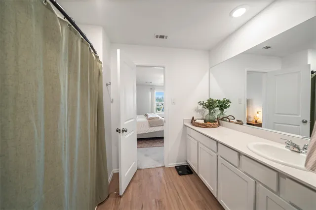 a spacious bathroom with a sink a mirror and a shower