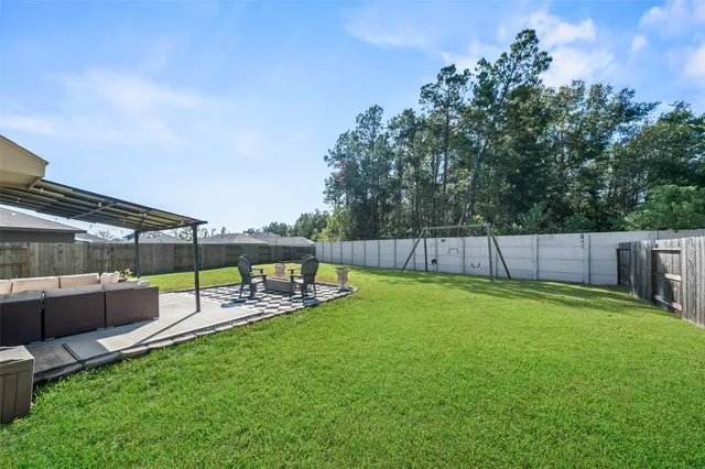 a view of a backyard with swimming pool