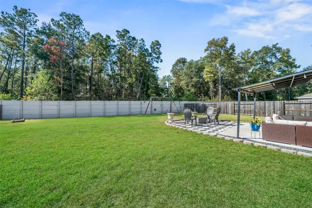 a view of yard with swimming pool and bench in the background