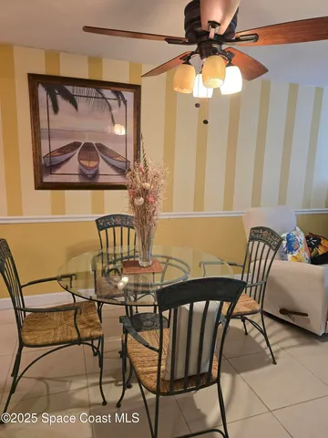 a view of a dining room with furniture and a chandelier