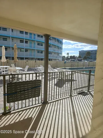 a view of a balcony with wooden floor