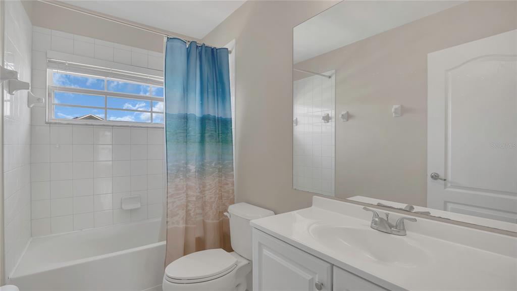 545 Fairhaven Drive Davenport, FL 33837 - Photo 16 of 23 a bathroom with a sink toilet and shower