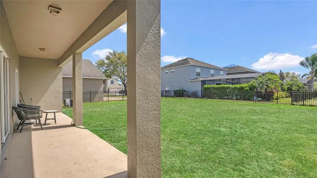 a view of a patio with a table and chairs under an umbrella