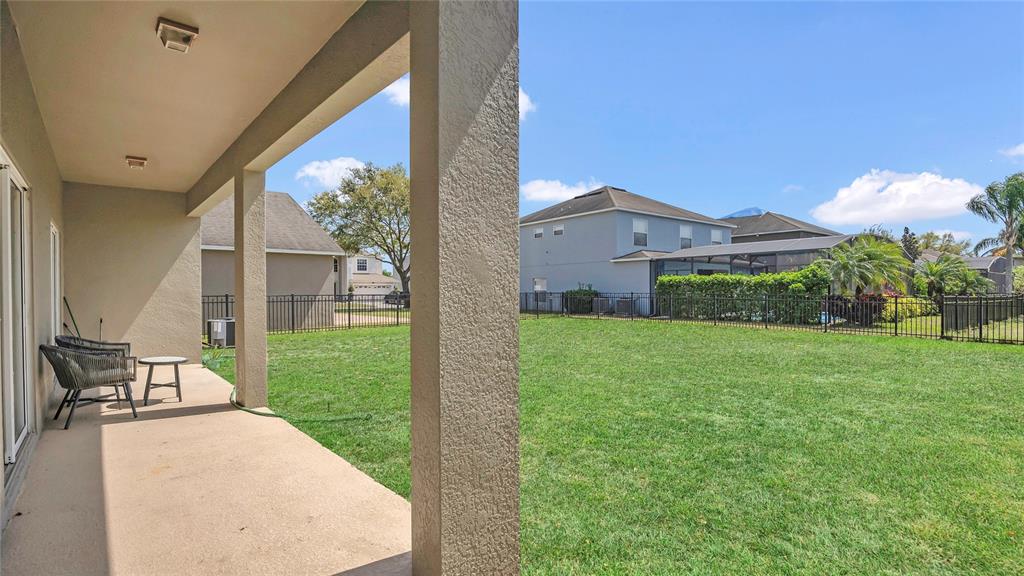 545 Fairhaven Drive Davenport, FL 33837 - Photo 18 of 23 a view of a patio with a table and chairs under an umbrella