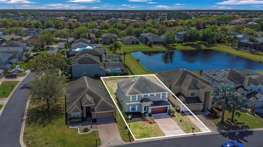 545 Fairhaven Drive Davenport, FL 33837 - Photo 20 of 23 an aerial view of a house with a lake view