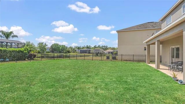 a view of a backyard with grass and a large window