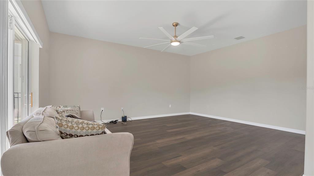 545 Fairhaven Drive Davenport, FL 33837 - Photo 6 of 23 a living room with furniture and a ceiling fan
