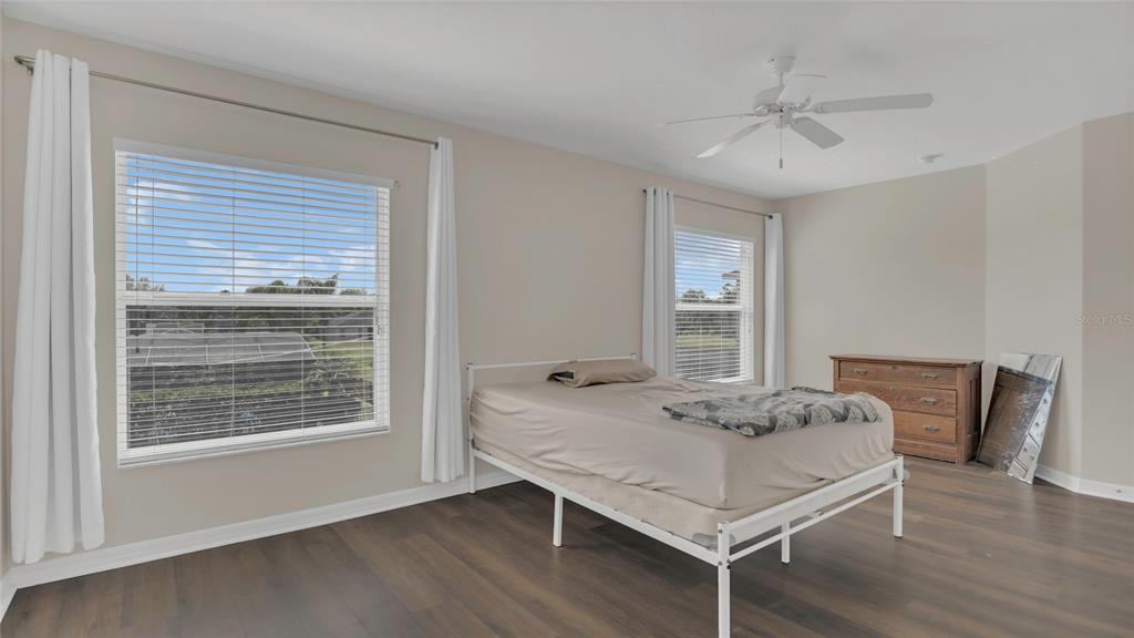 545 Fairhaven Drive Davenport, FL 33837 - Photo 8 of 23 a bedroom with a bed and a table in it