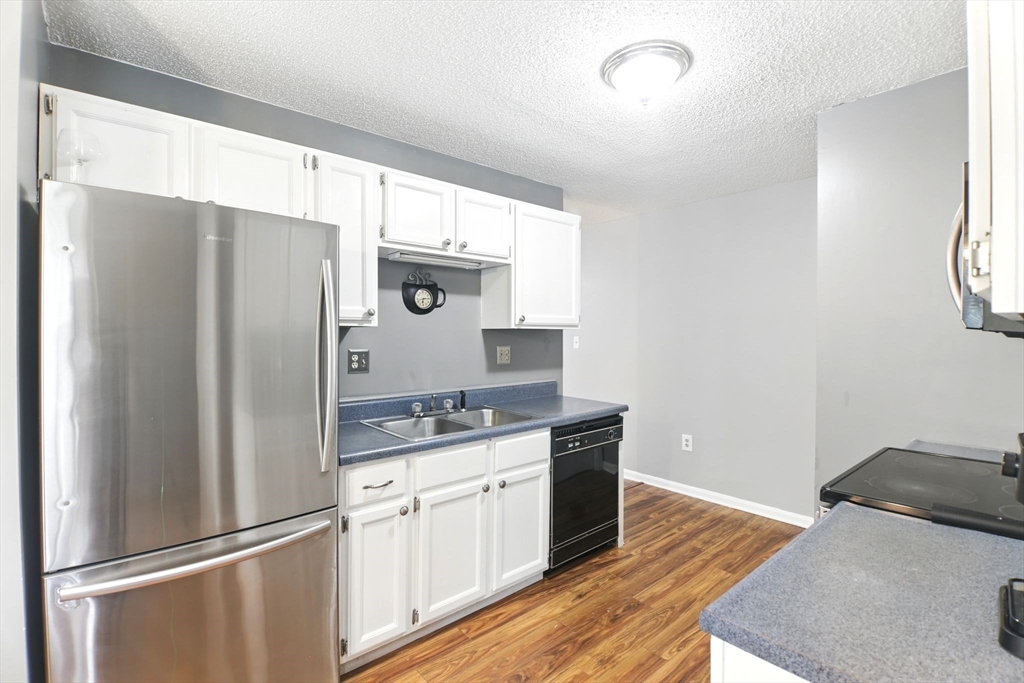 59 Castlegate Drive, Unit B Springfield, MA 01129 - Photo 18 of 42 a kitchen with stainless steel appliances a refrigerator sink and cabinets