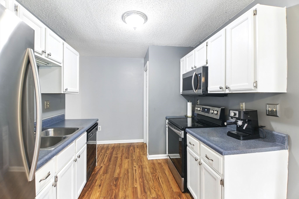 59 Castlegate Drive, Unit B Springfield, MA 01129 - Photo 19 of 42 a kitchen with granite countertop a sink and steel appliances