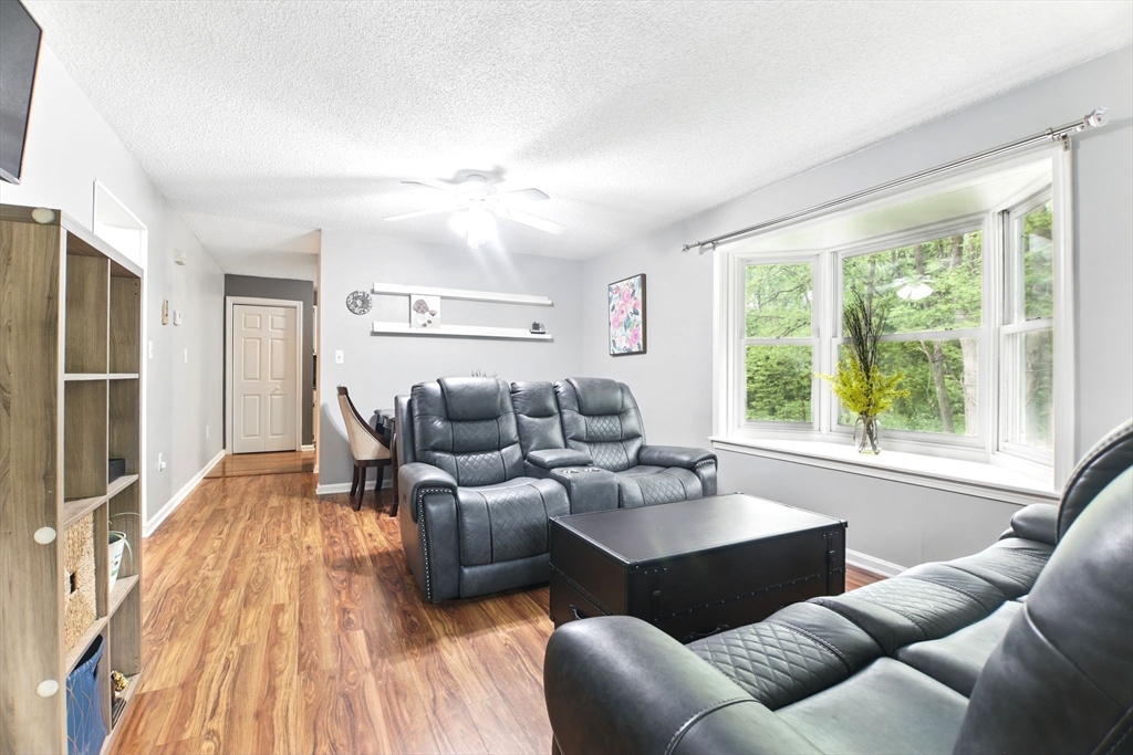59 Castlegate Drive, Unit B Springfield, MA 01129 - Photo 2 of 42 a living room with furniture and a large window
