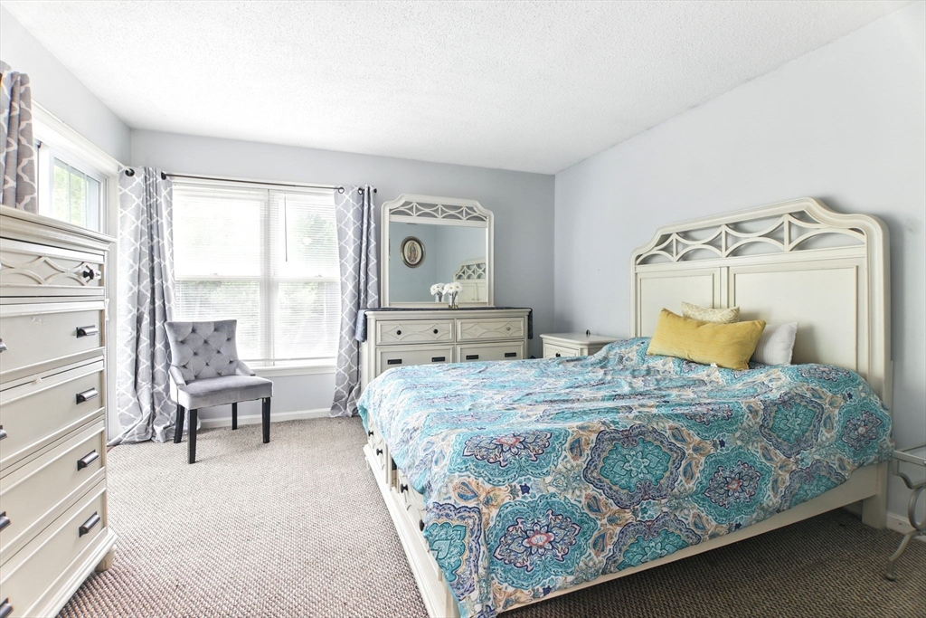 59 Castlegate Drive, Unit B Springfield, MA 01129 - Photo 25 of 42 a bedroom with a bed chair and window