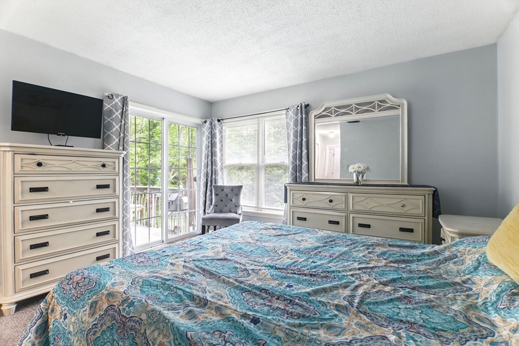 59 Castlegate Drive, Unit B Springfield, MA 01129 - Photo 27 of 42 a bedroom with a bed and flat screen tv