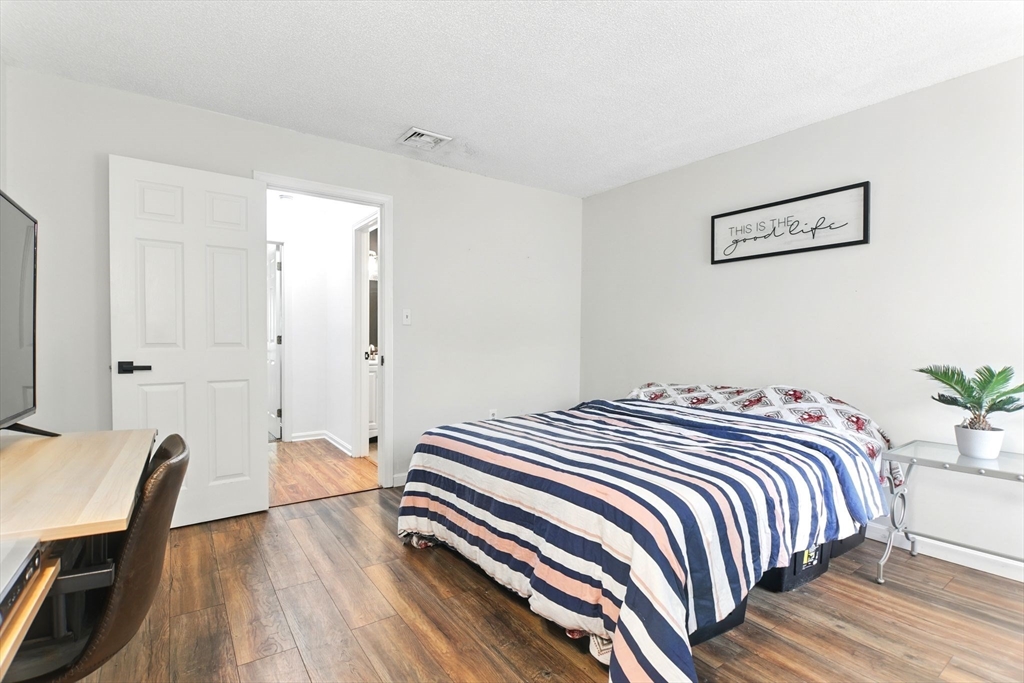 59 Castlegate Drive, Unit B Springfield, MA 01129 - Photo 31 of 42 a bedroom with a bed and a chair