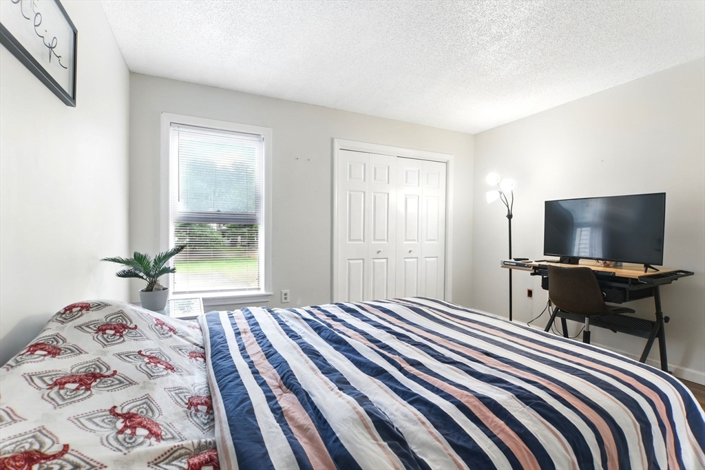 59 Castlegate Drive, Unit B Springfield, MA 01129 - Photo 32 of 42 a bedroom with a bed and a flat screen tv