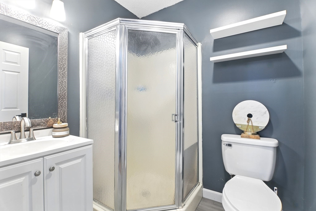 59 Castlegate Drive, Unit B Springfield, MA 01129 - Photo 33 of 42 a bathroom with a toilet a sink and a mirror