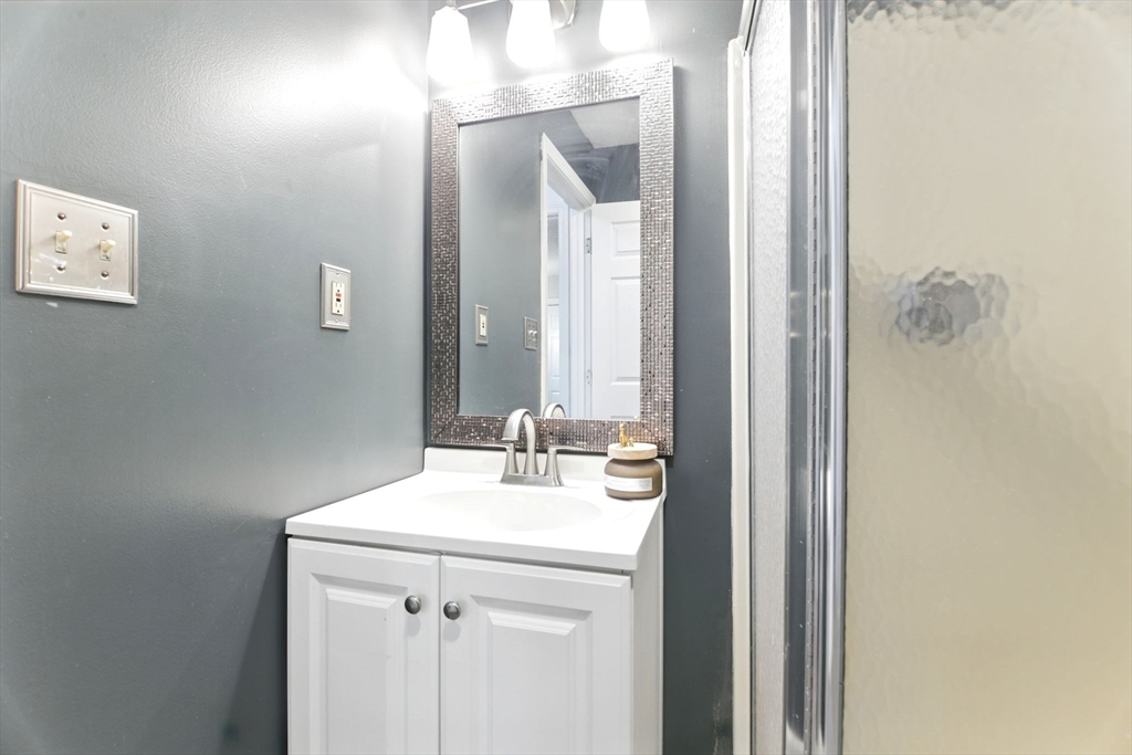 59 Castlegate Drive, Unit B Springfield, MA 01129 - Photo 34 of 42 a bathroom with a sink and a mirror